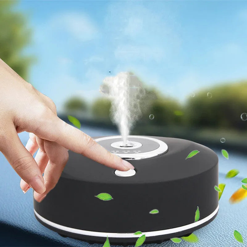 USB-powered plastic car aromatherapy spray machine in black, grey, or white on a car dashboard.