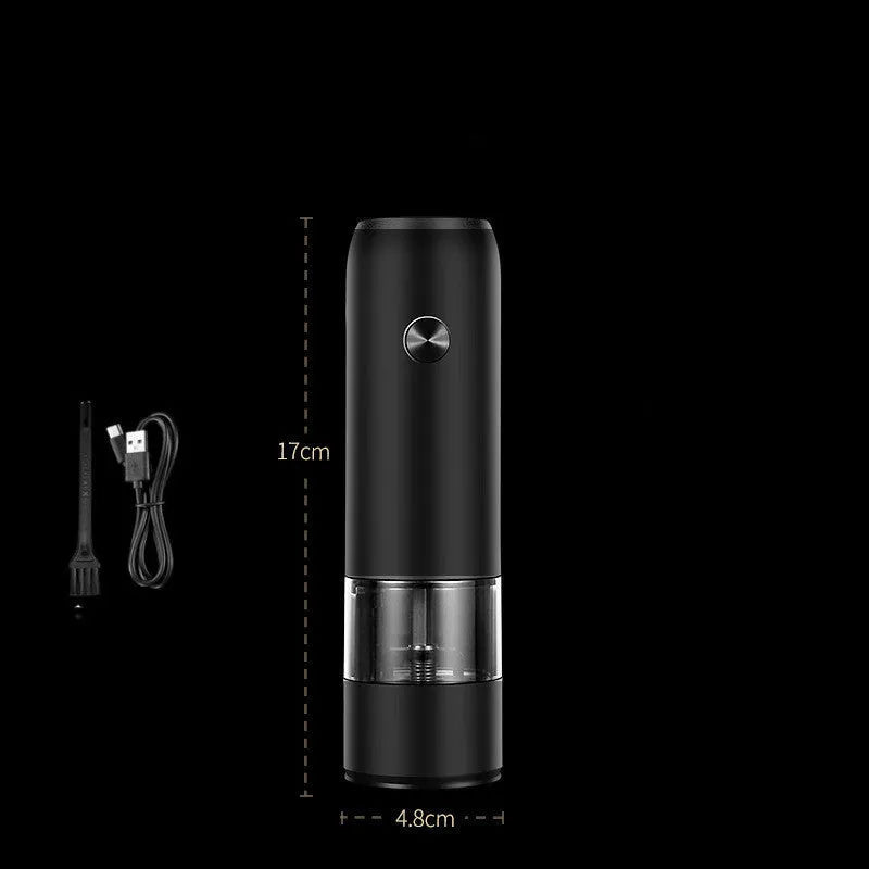 Black and silver rechargeable electric pepper grinder with clear acrylic body on a kitchen counter