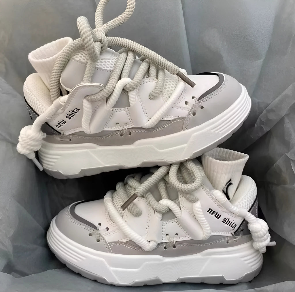 Women's grey clunky sneakers with thick rubber sole and round toe, shown with blue and black colour options.