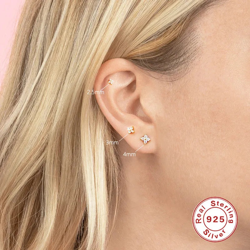 S925 sterling silver stud earrings with a geometric flower and crystal design in gold or platinum finish.