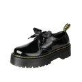 Black and white women's thick-soled small leather shoes with lace-up closure, ribbons, and cross straps.