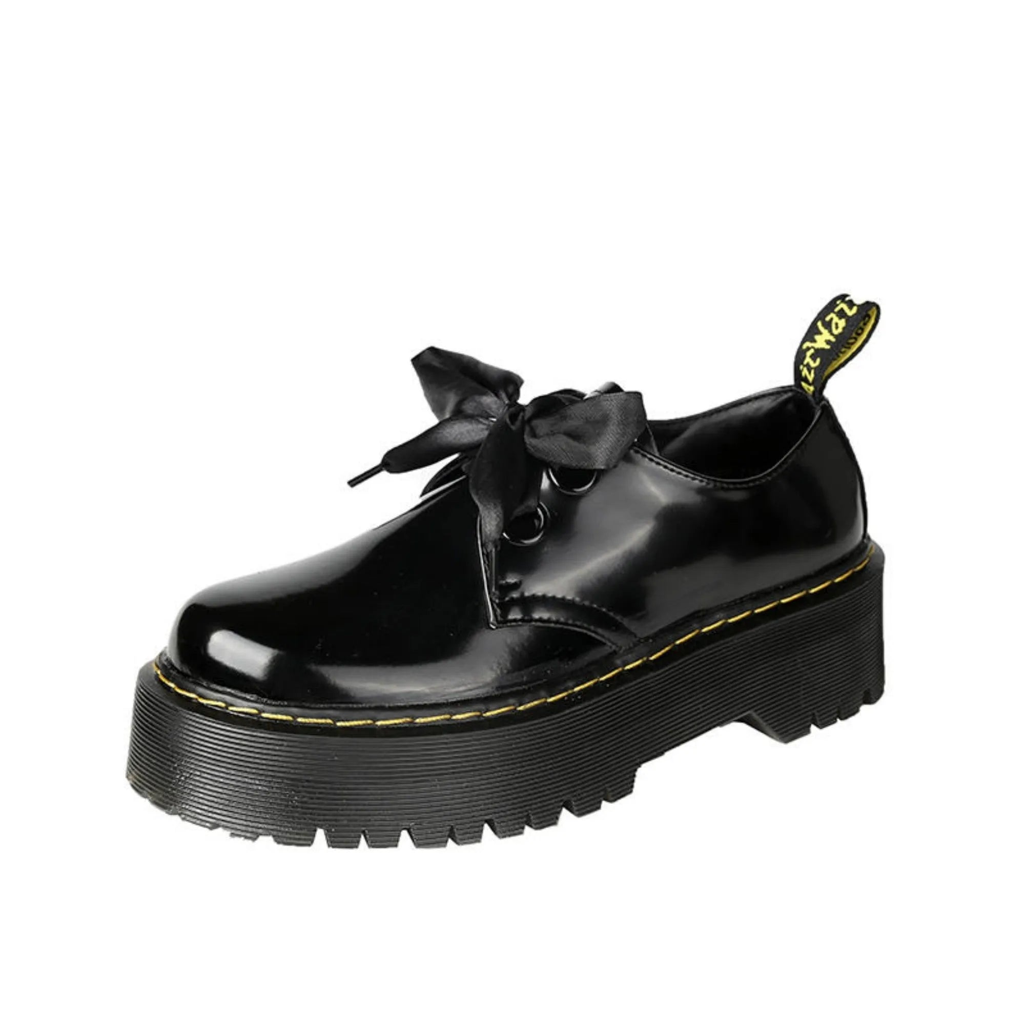 Black and white women's thick-soled small leather shoes with lace-up closure, ribbons, and cross straps.