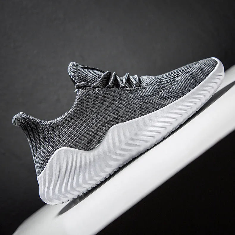 Men's breathable ultra-light running shoes with white upper and grey sole, side view