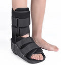 Grey Achilles tendon rehabilitation boot with aluminium frame and adjustable straps, shown with attached walking shoe.