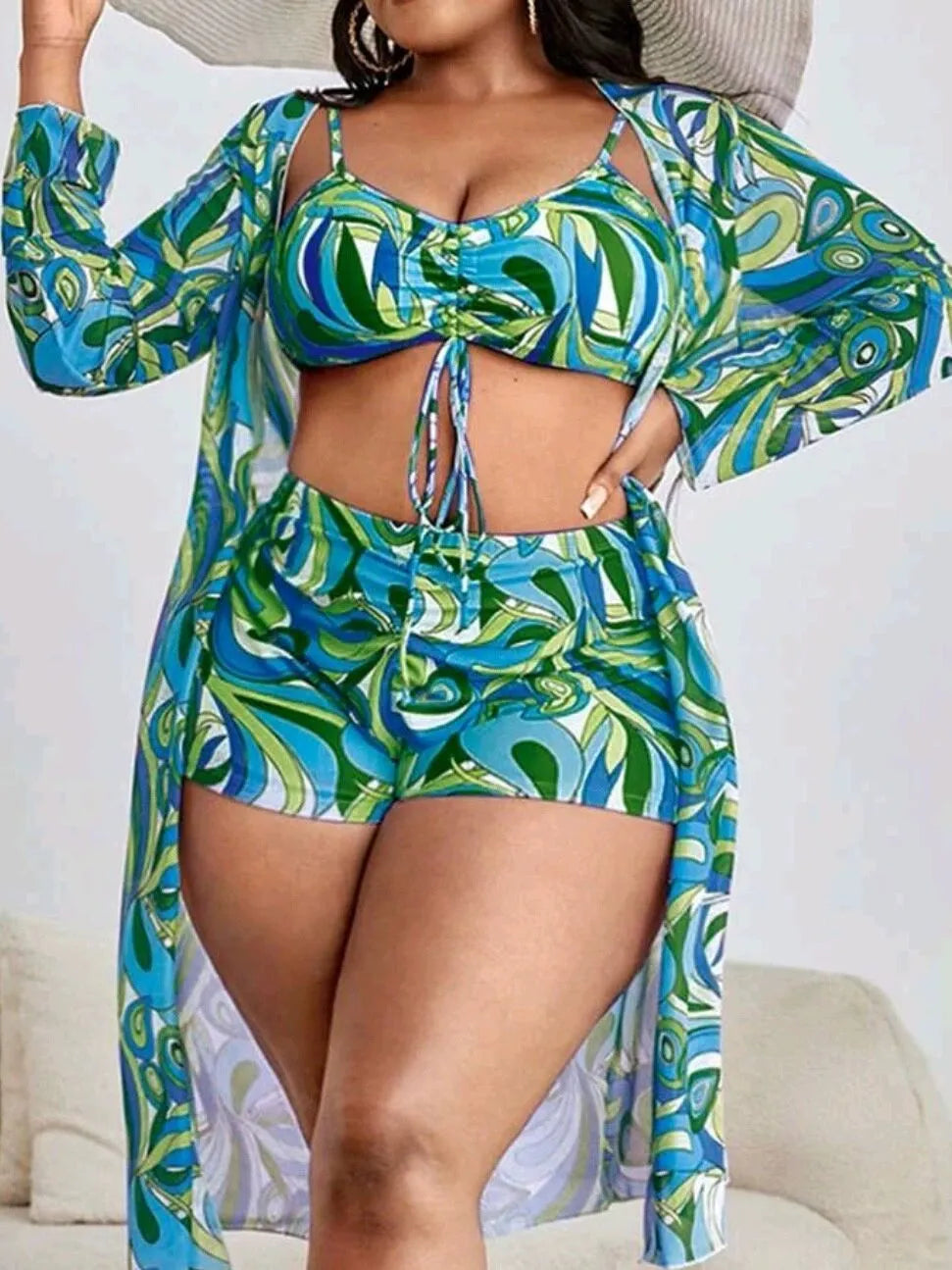 Women's floral print bikini three-piece set with bra, briefs, and a matching cardigan cover-up.