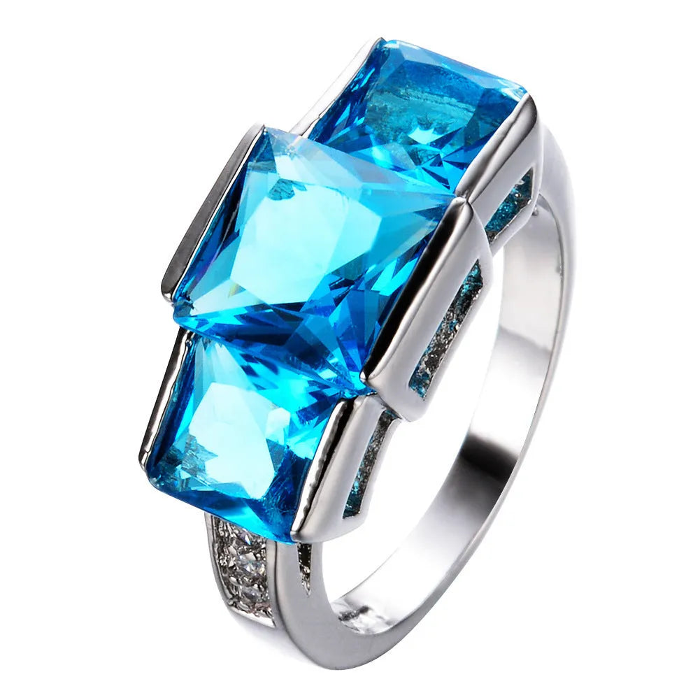 Geometric copper women's ring in various electroplated colours including red, blue, and green, showing size options.