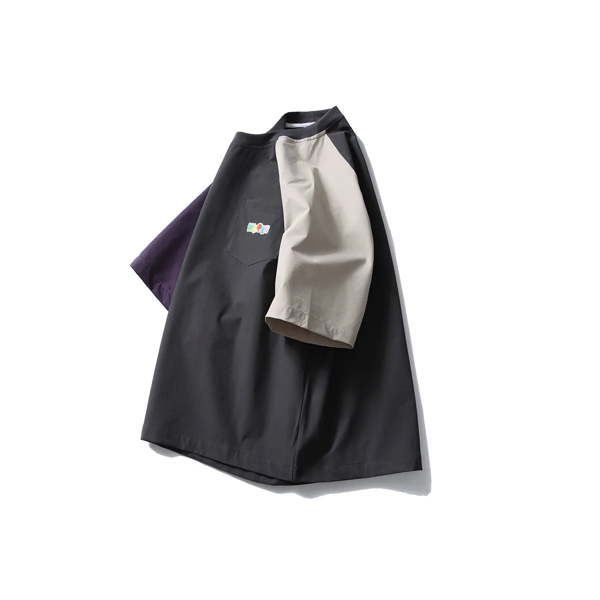 Dark grey loose fit t-shirt with light coloured raglan sleeves on a hanger