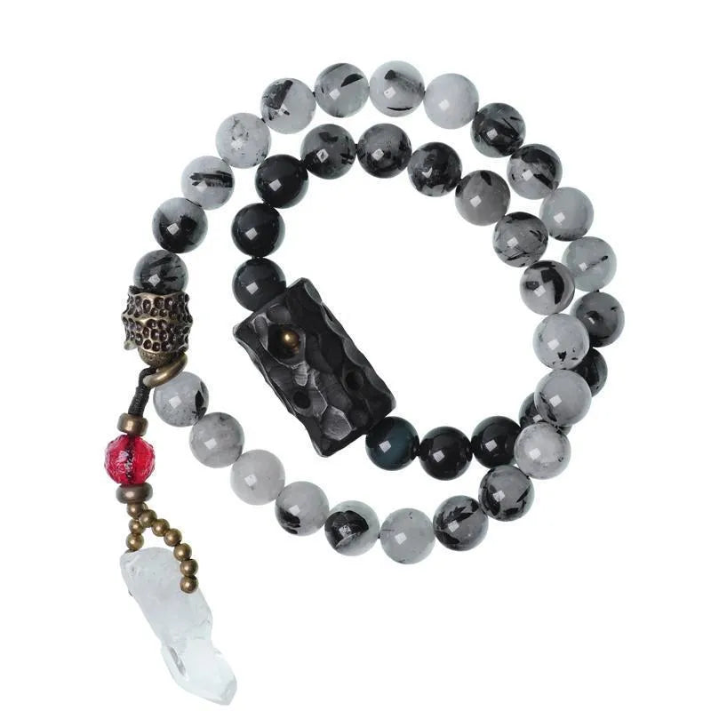 Ethnic style black hair crystal bracelet with white crystal tassel showing lacing construction