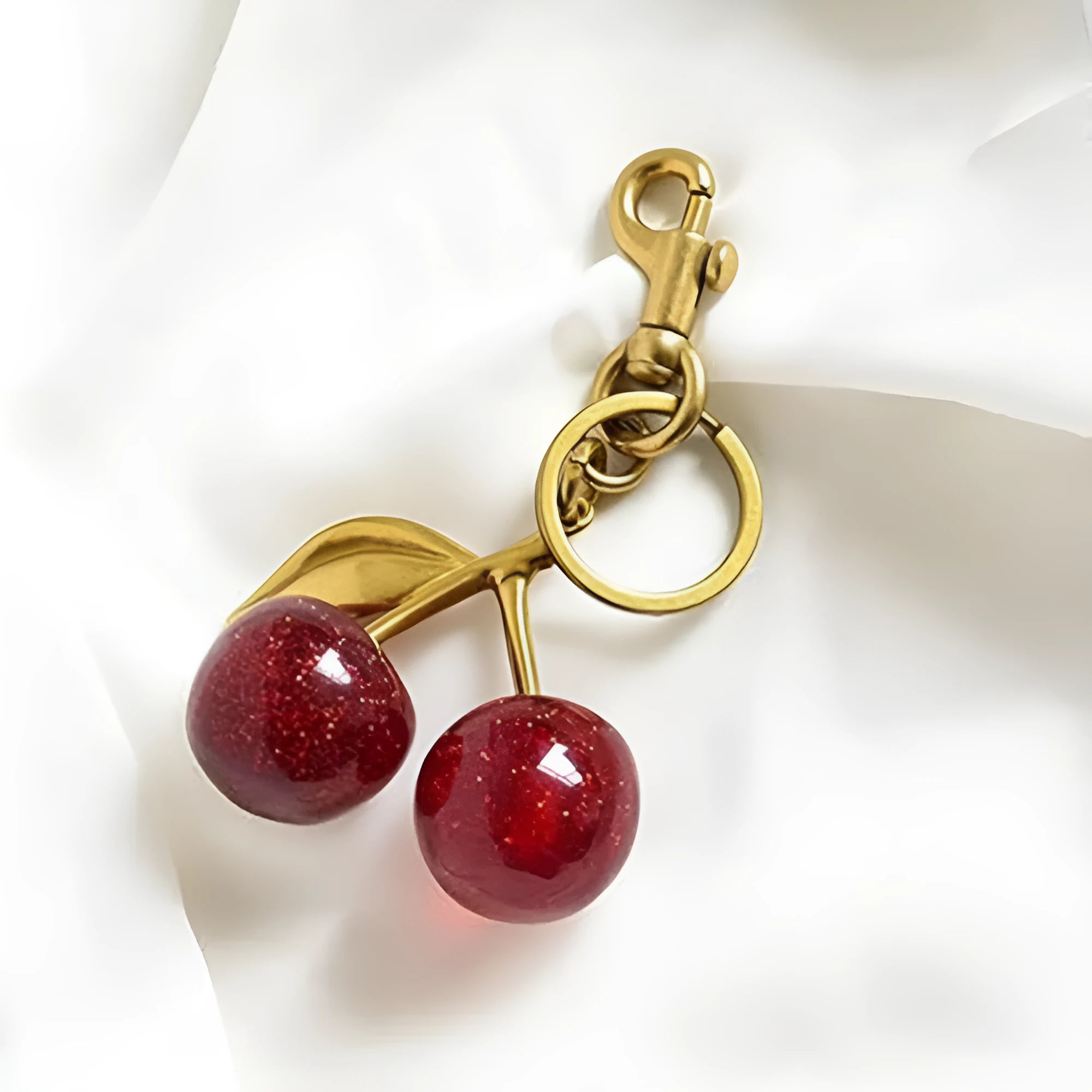 Red zinc alloy cherry-shaped keychain pendant with a three-dimensional design.
