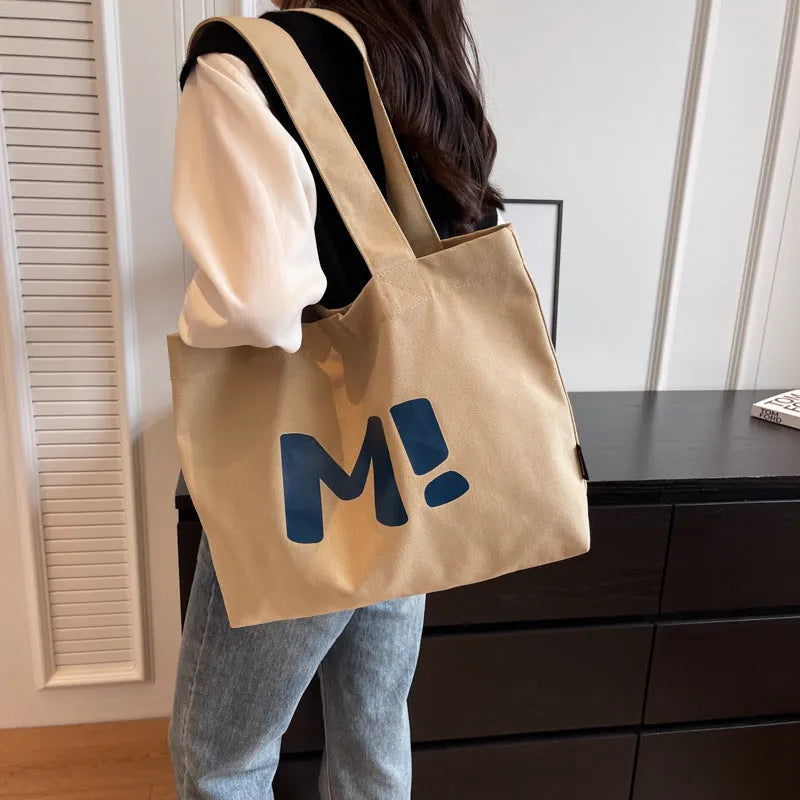 Letter print canvas shoulder bag in dark brown, large capacity tote with shoulder strap for women and girls.