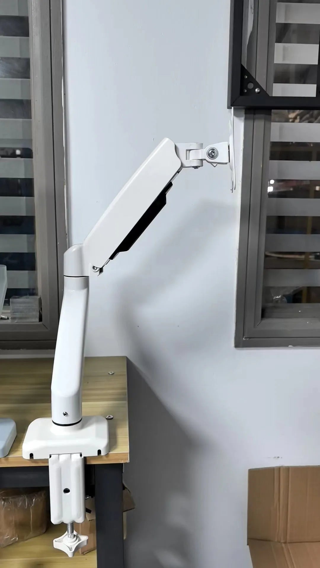 Black and white LCD screen rotating telescopic bracket on table with adjustable height