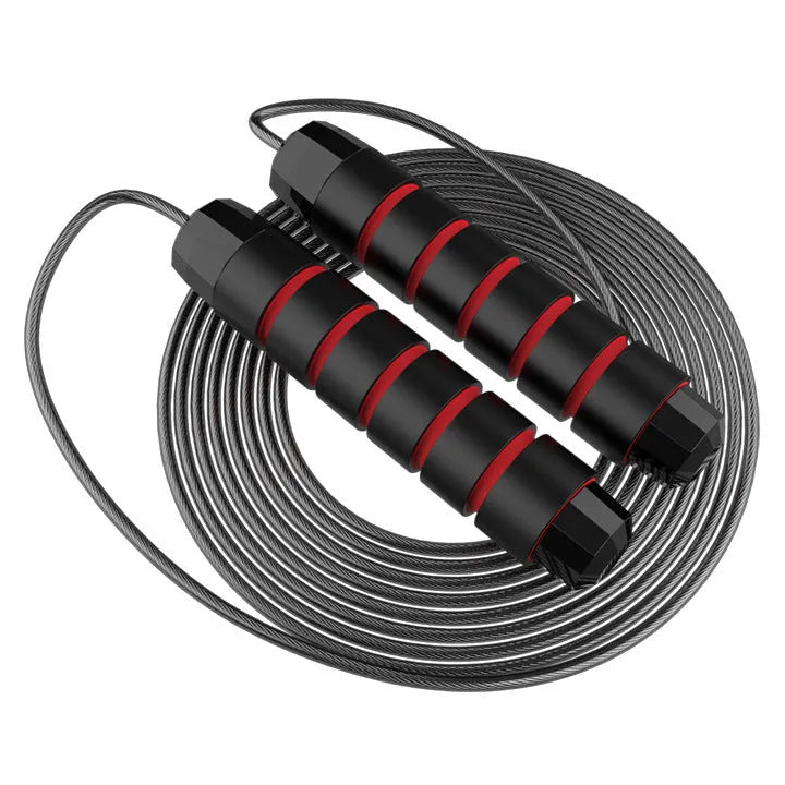 Steel wire jump rope with black PP handle on a dark background for fitness training