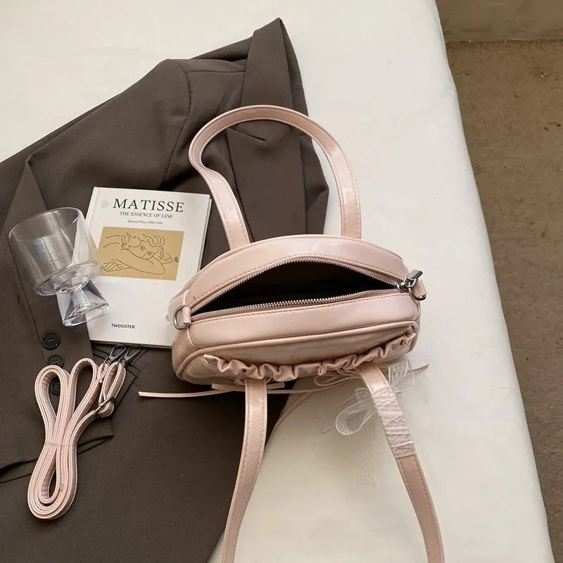 Women's casual PU shoulder handbag with a large bandage bow detail and phone compartment.