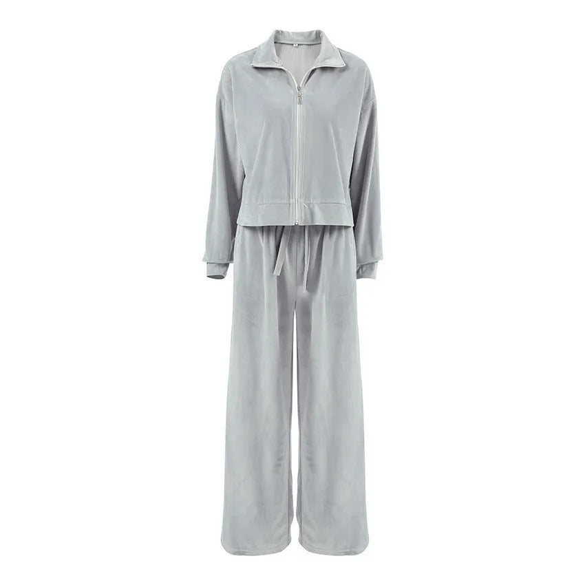 Women's velvet-look two-piece suit with drop-shoulder top and full-length trousers, available in grey or pink, sizes S to L