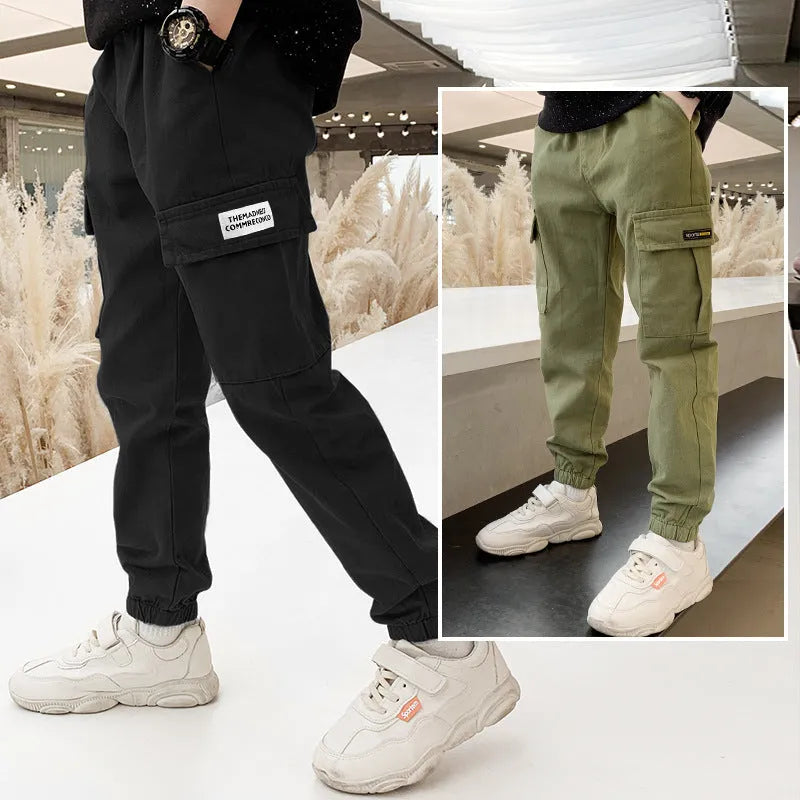 Boys' casual cotton trousers in army green, shown laid flat with size label visible.