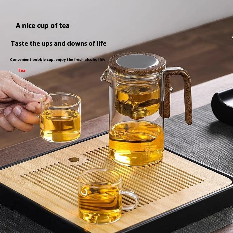 Innovative glass teapot with magnetic separation technology, wooden handle, and clear design for brewing and serving tea