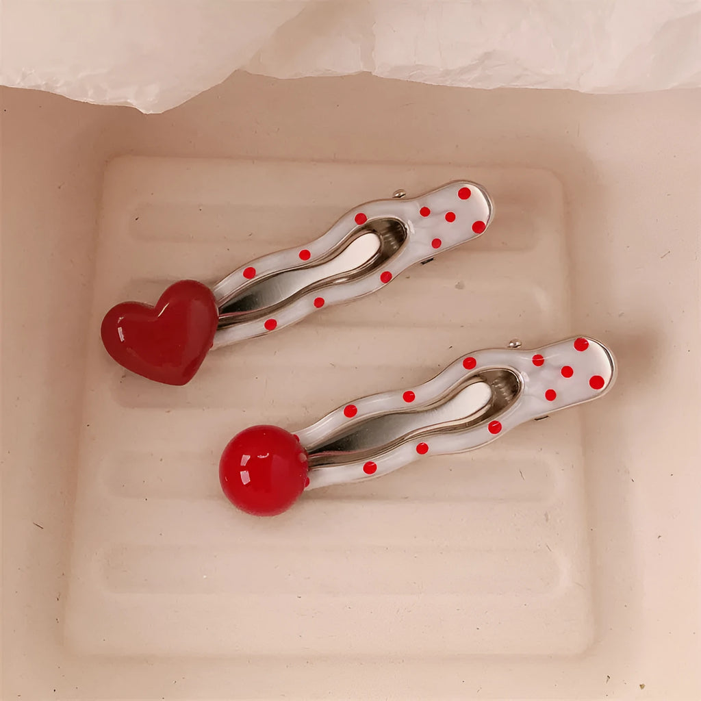Red love heart shaped hair clip with dotted patterns and willow leaf designs on a barrette
