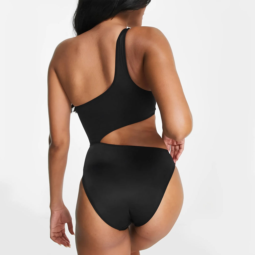Black women's one-piece swimsuit with hollow cut-outs and white contrast stitching.