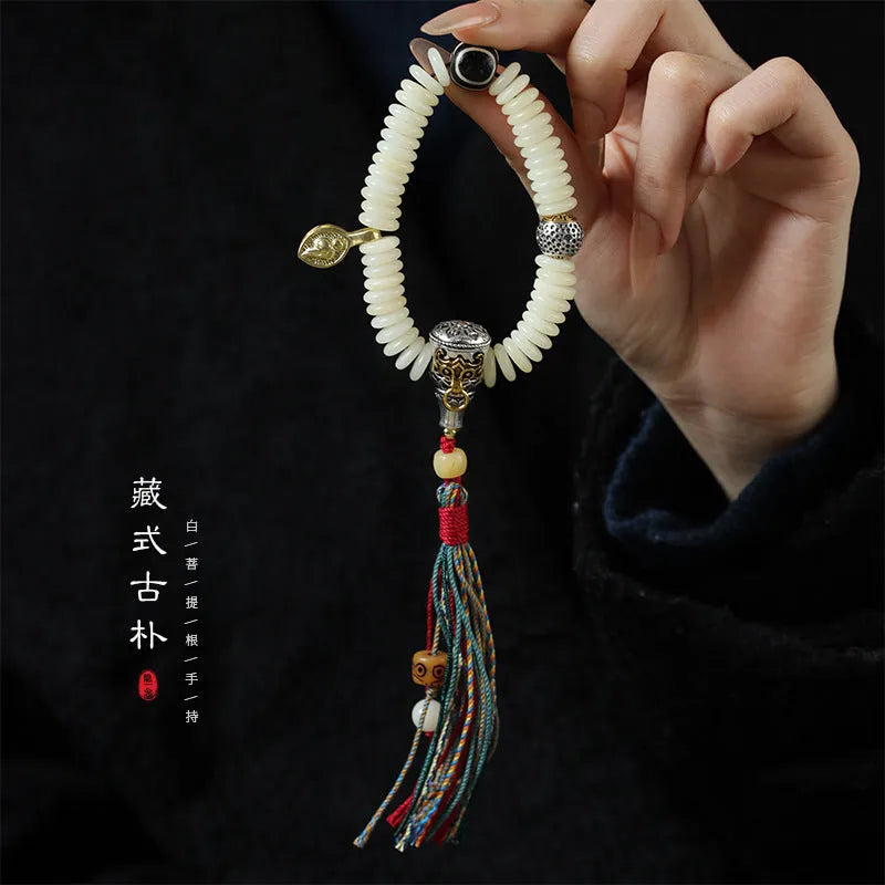 White Bodhi seed bracelet and handheld mala with 3x10mm beads on a neutral background.