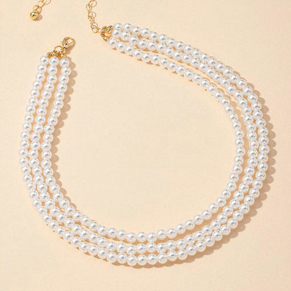 Multilayered pearl necklace with a cascading design, inspired by the fashion trends of the Roaring 20s