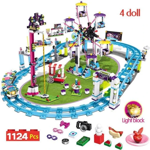 A detailed LEGO amusement park with a roller coaster, Ferris wheel, and drop tower, along with four mini-doll figures in summer outfits.