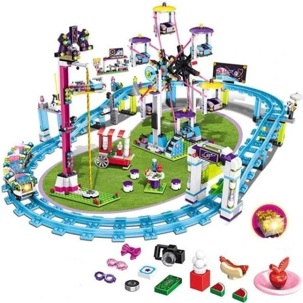 A detailed LEGO amusement park with a roller coaster, Ferris wheel, and drop tower, along with four mini-doll figures in summer outfits.